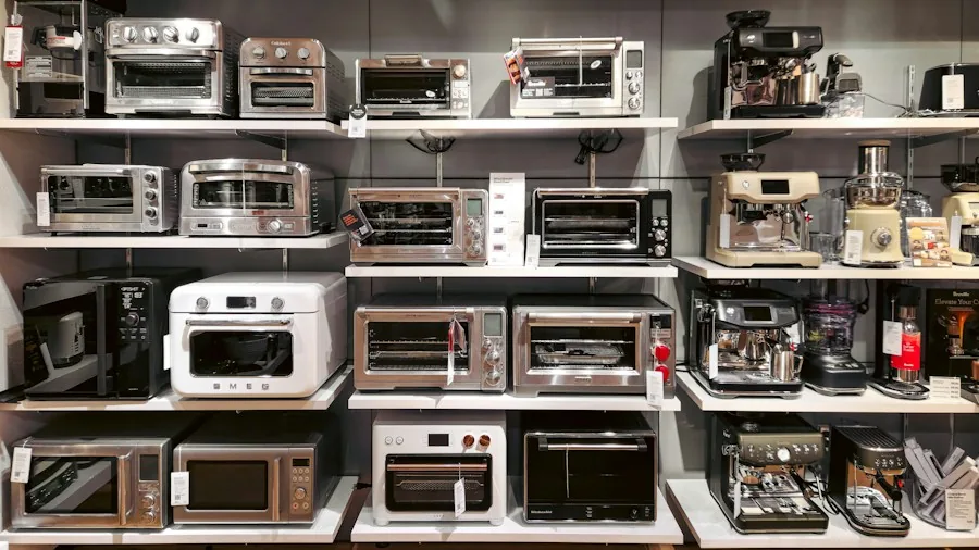 Family comparing appliance features in modern kitchen while discussing energy efficiency and purchase options