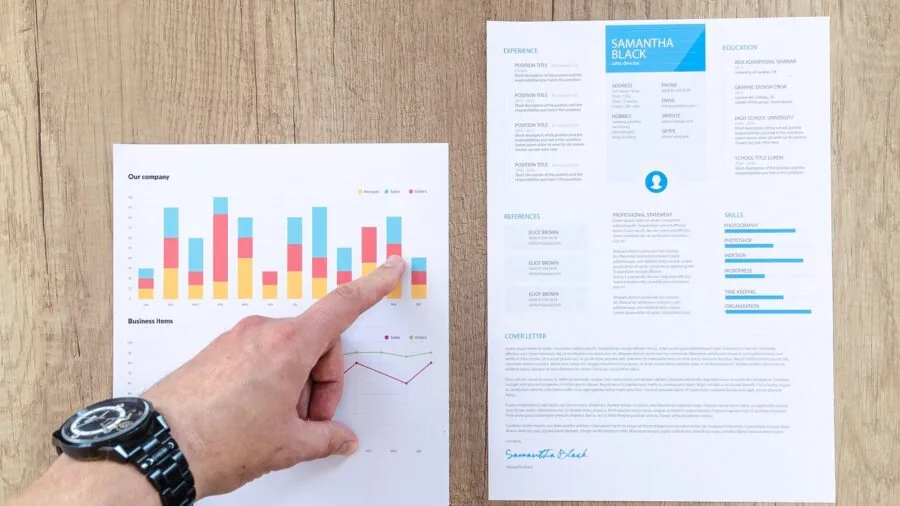 Person studying data charts and graphs on a laptop, examining information critically